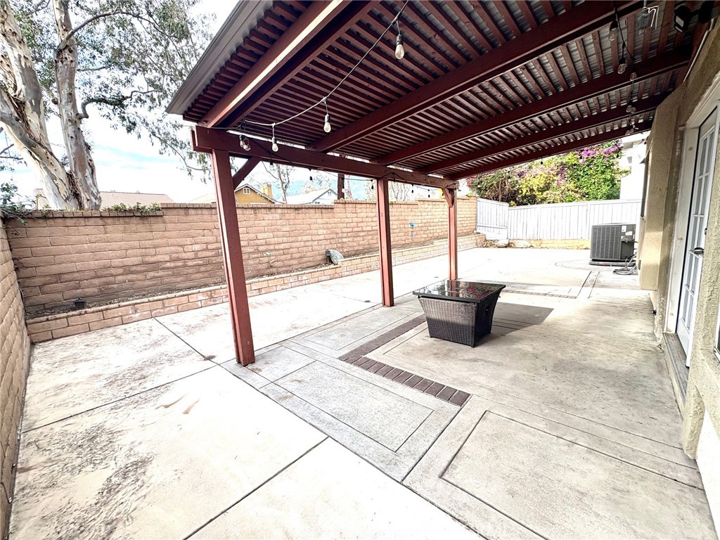 7280 Comiso Way Rancho Cucamonga, CA 91701 - Photo 64 of 66 a view of a backyard of a house with wooden floor outdoor seating and yard in the back