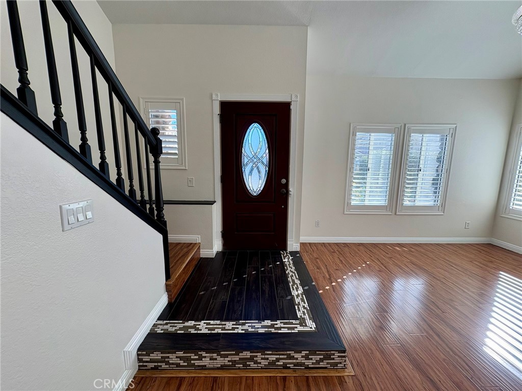 7280 Comiso Way Rancho Cucamonga, CA 91701 - Photo 7 of 66 a view of an entryway with wooden floor