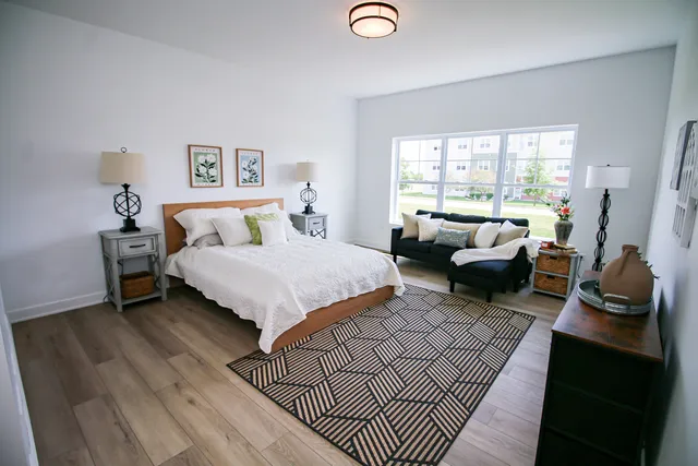 a living room with furniture a rug and a large window