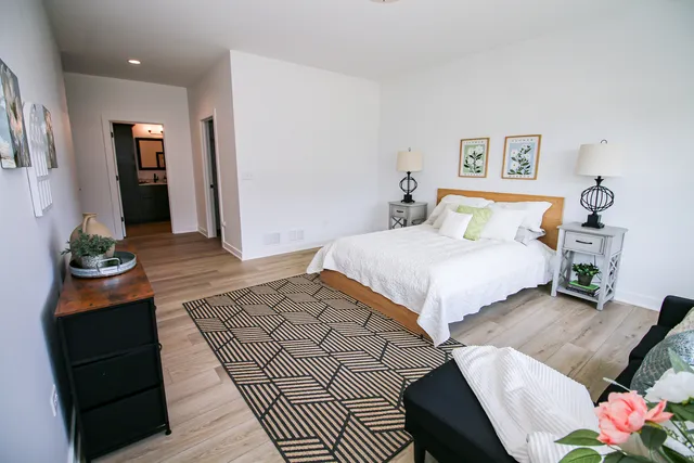 a bedroom with a bed and a dresser