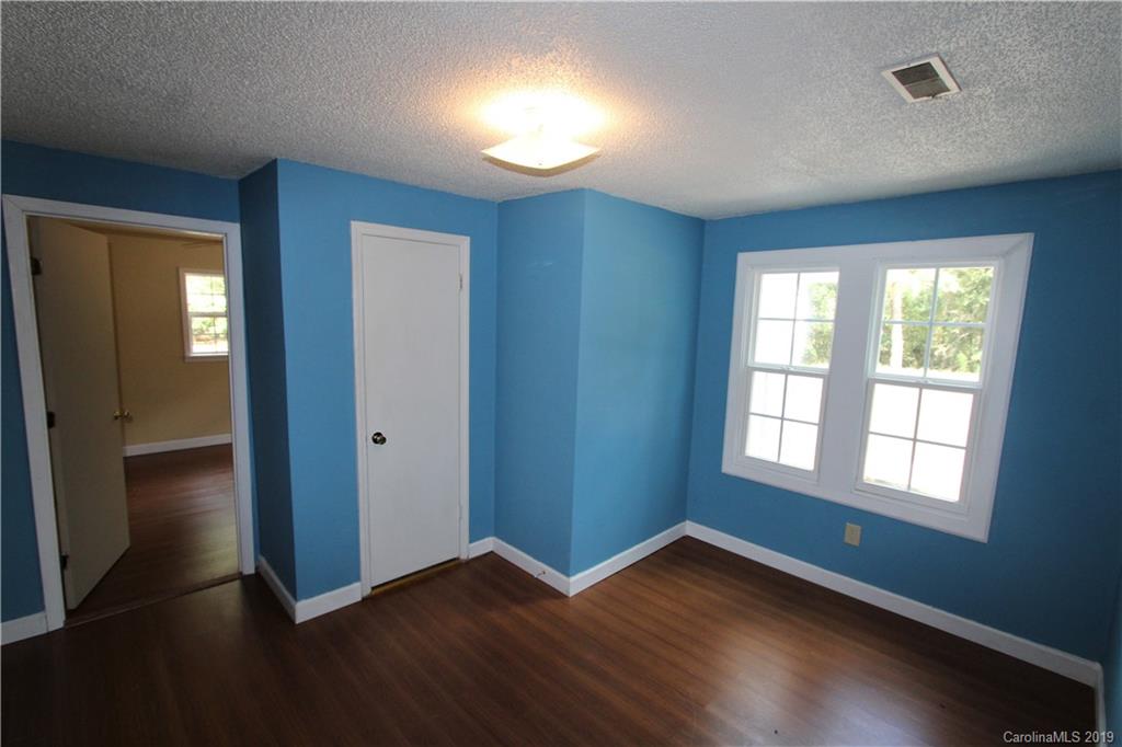 2725 Peru Road Morven, NC 28119 - Photo 14 of 22 an empty room with wooden floor and windows