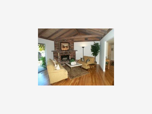 19907 Bonnie Ridge Way Saratoga, CA 95070 - Photo 2 of 6 a living room with furniture and a flat screen tv