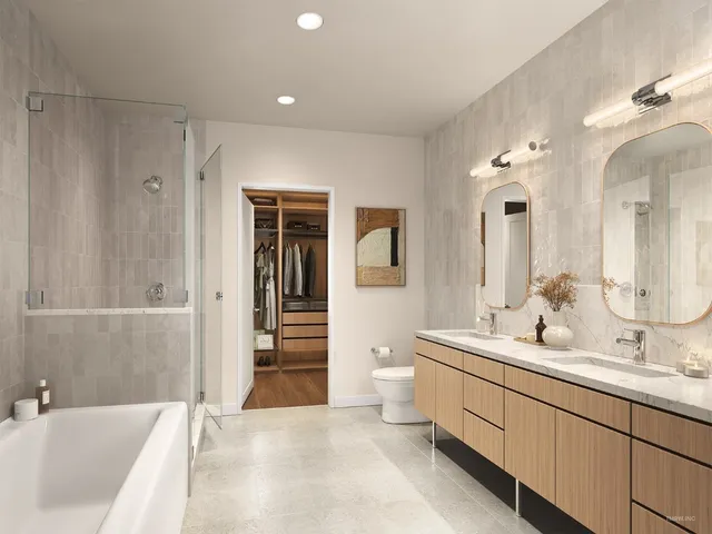 a bathroom with a double vanity sink mirror and bathtub