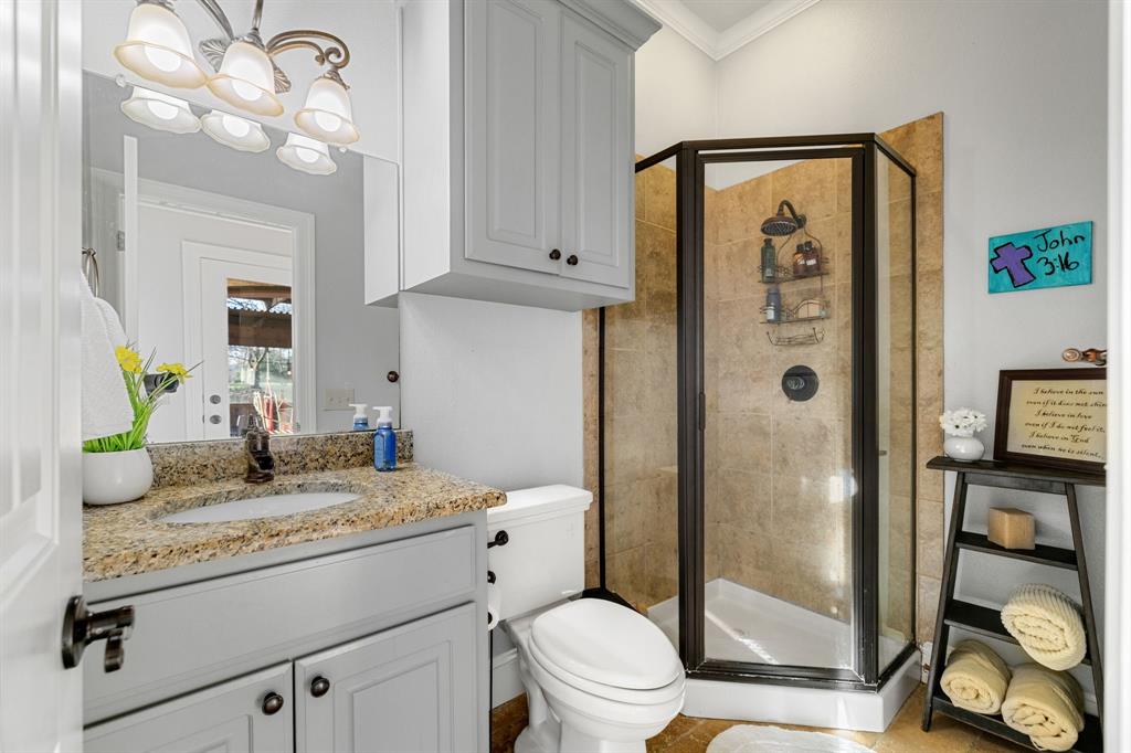 689 Jim Cannon Road Van Alstyne, TX 75495 - Photo 24 of 35 Bathroom with a shower stall, vanity, crown molding, and suspended lighting