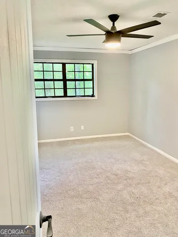 a view of an empty room with a window