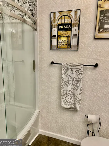 a bathroom with a bathtub and shower