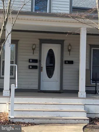 a front view of a house with a wooden bench