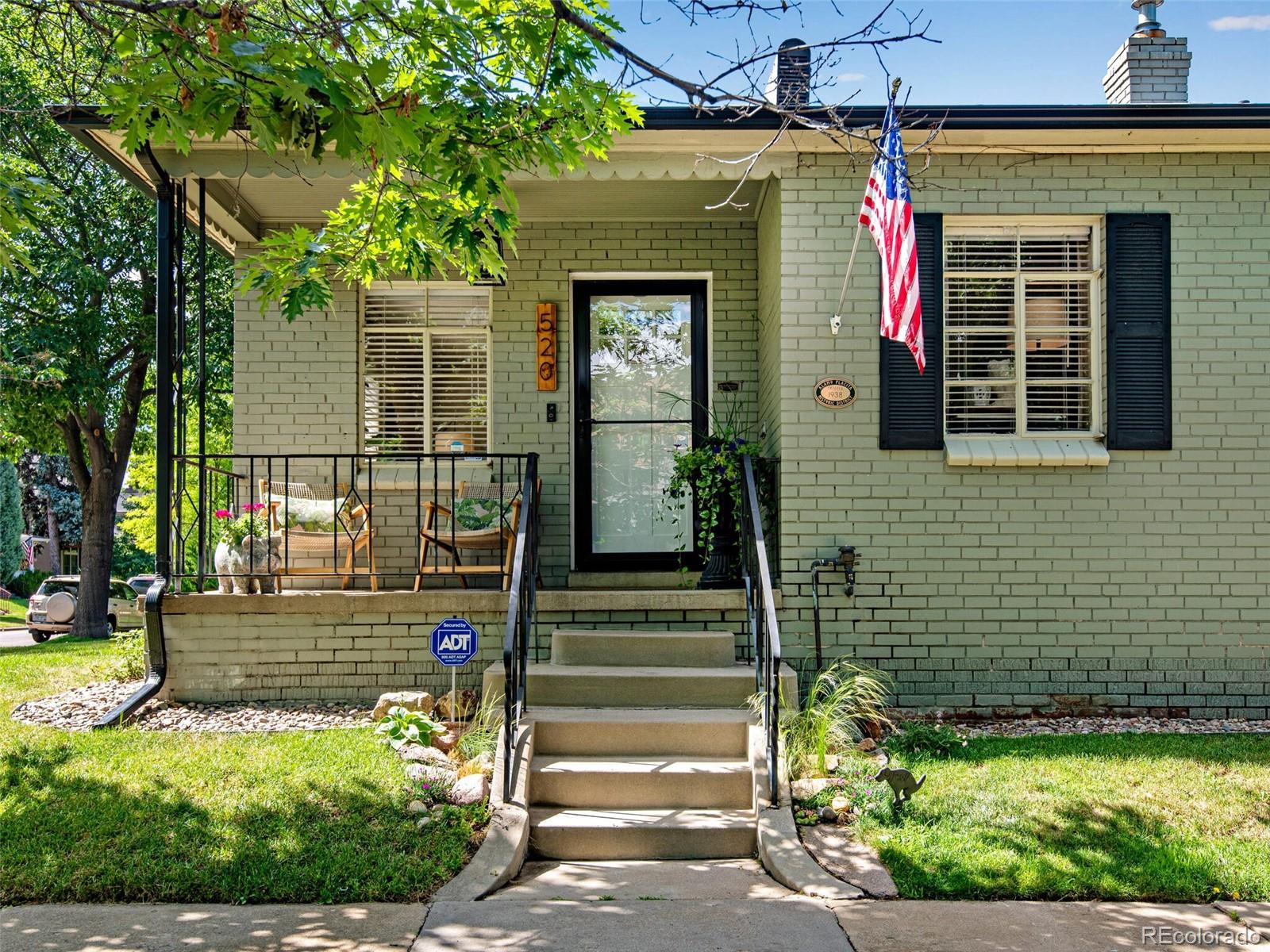 520 East 5th Avenue Denver, CO 80203 - Photo 1 of 40 a front view of a house with a garden