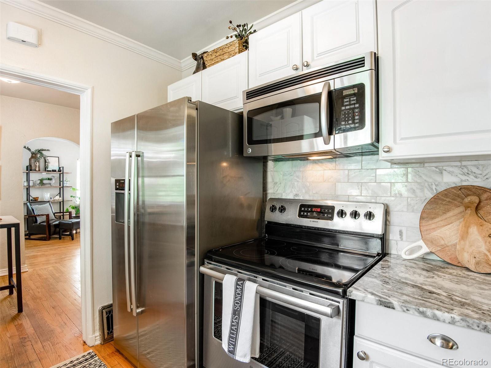 520 East 5th Avenue Denver, CO 80203 - Photo 14 of 40 a kitchen with stainless steel appliances granite countertop a stove and a refrigerator