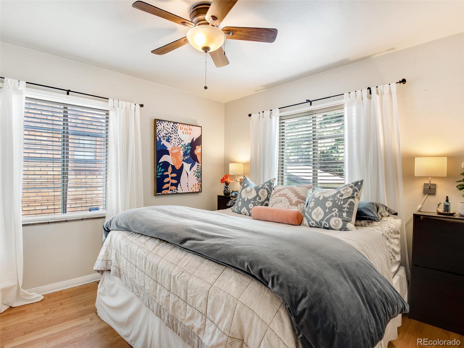 520 East 5th Avenue Denver, CO 80203 - Photo 16 of 40 a bedroom with a large bed and a chandelier