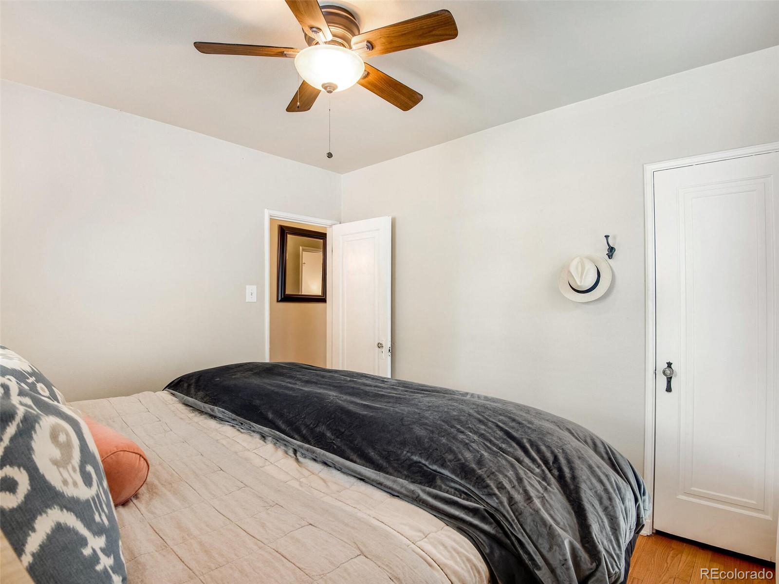 520 East 5th Avenue Denver, CO 80203 - Photo 17 of 40 a bedroom with a bed and a chandelier
