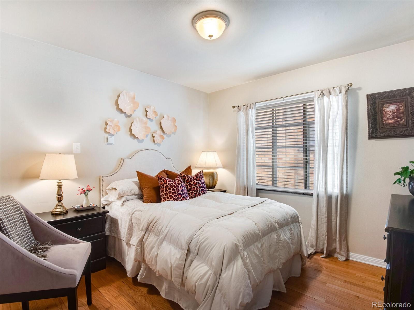 520 East 5th Avenue Denver, CO 80203 - Photo 18 of 40 a bedroom with a bed and a window