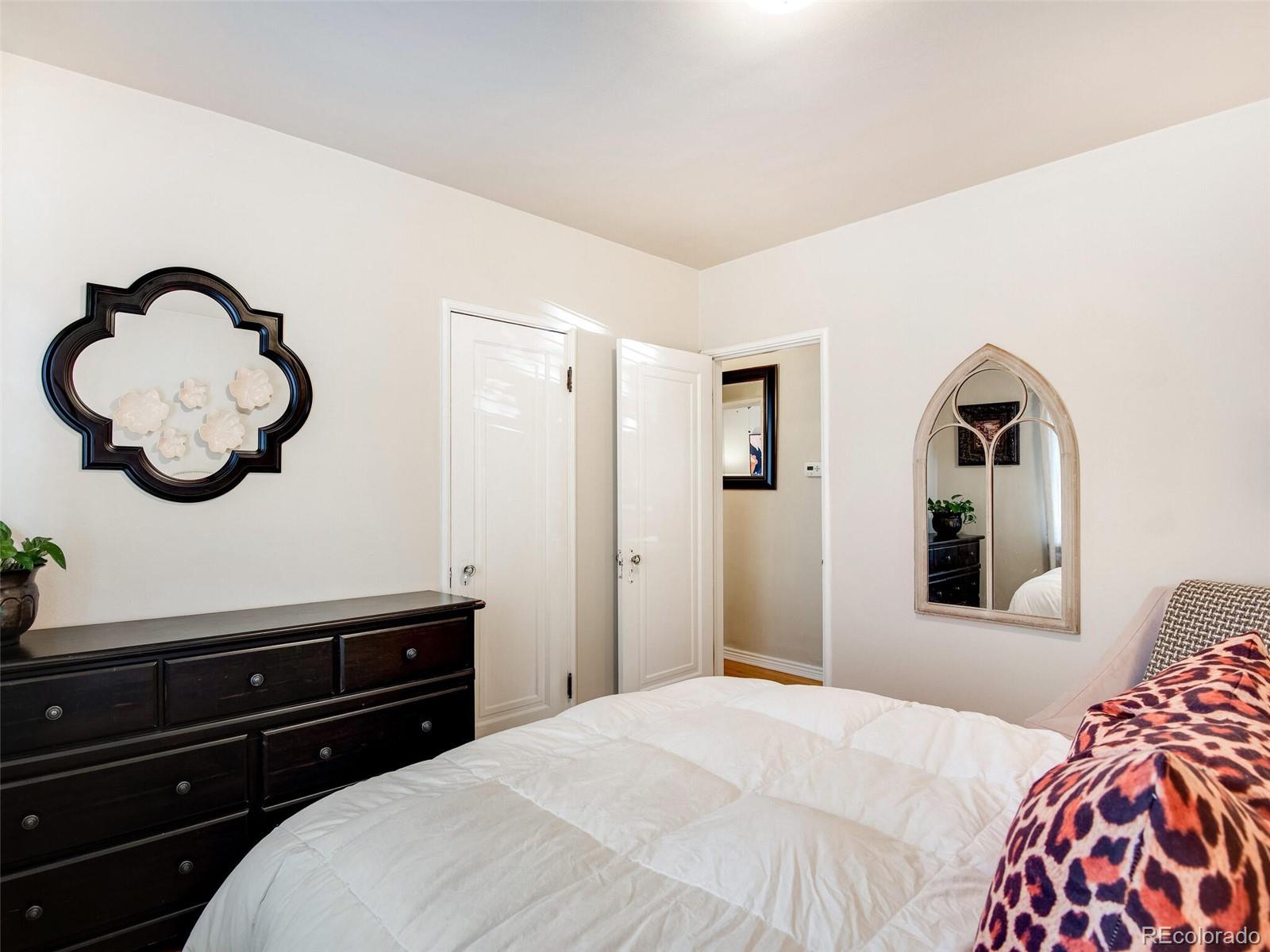 520 East 5th Avenue Denver, CO 80203 - Photo 19 of 40 a bedroom with a bed and a dresser