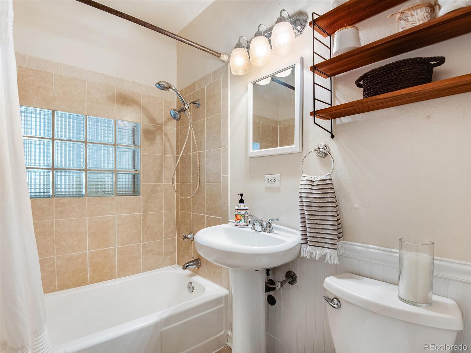 520 East 5th Avenue Denver, CO 80203 - Photo 20 of 40 a bathroom with a sink a toilet and shower