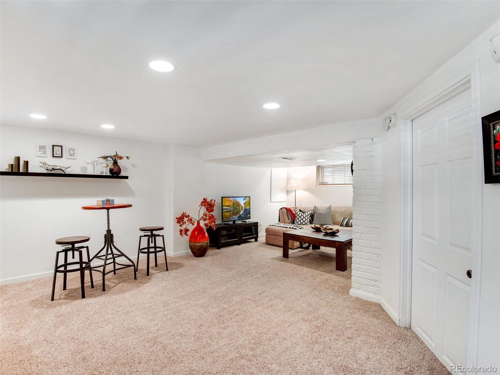 520 East 5th Avenue Denver, CO 80203 - Photo 22 of 40 a living room with furniture and a flat screen tv