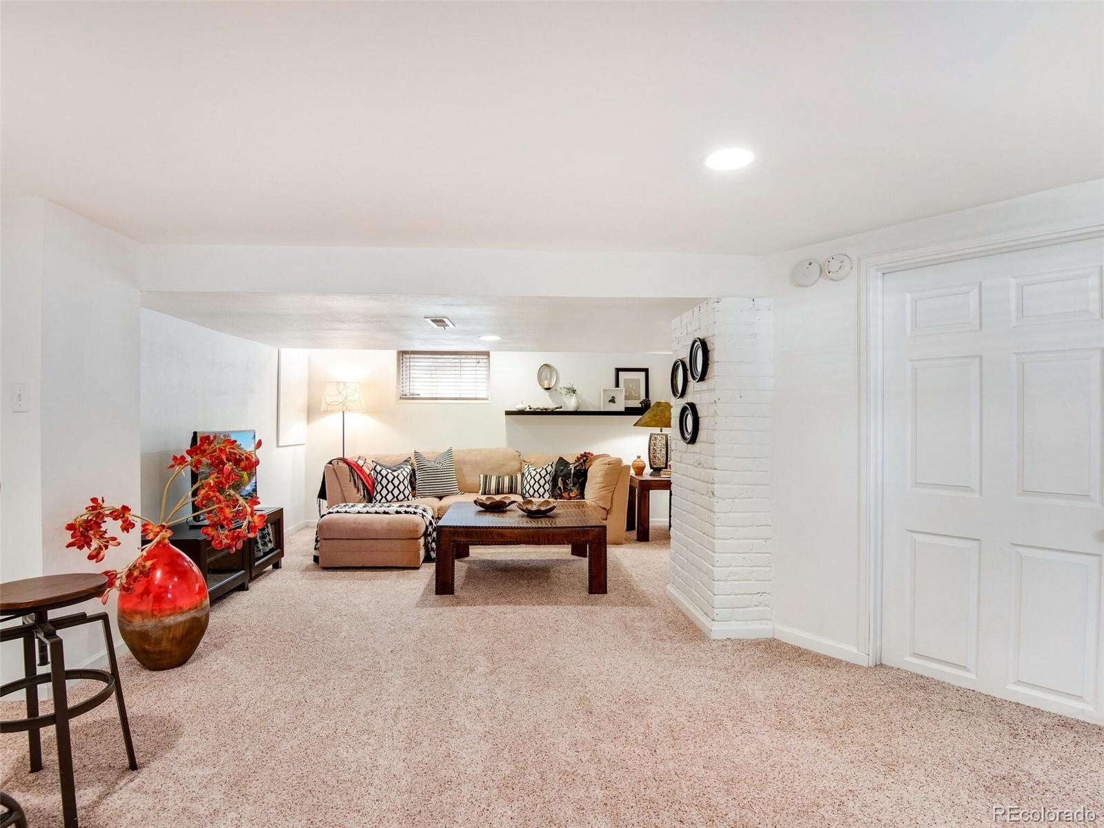 520 East 5th Avenue Denver, CO 80203 - Photo 23 of 40 a living room with furniture and a chandelier
