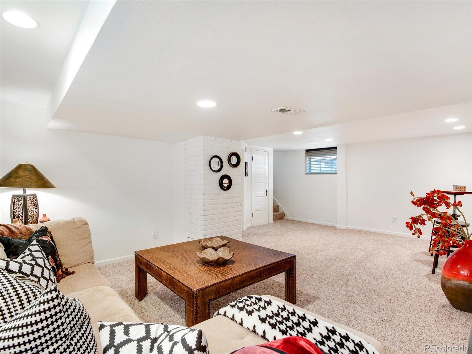 520 East 5th Avenue Denver, CO 80203 - Photo 24 of 40 a living room with furniture and a table