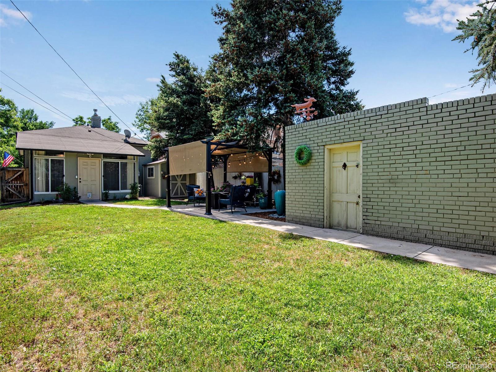 520 East 5th Avenue Denver, CO 80203 - Photo 31 of 40 a front view of a house with a garden and trees
