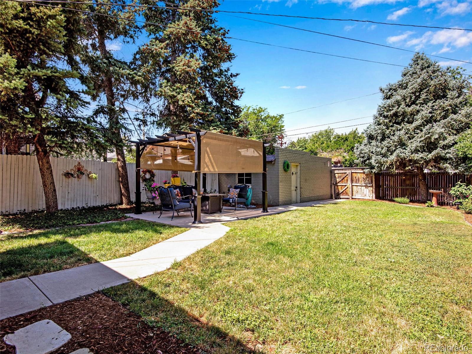 520 East 5th Avenue Denver, CO 80203 - Photo 32 of 40 a swimming pool with outdoor seating and yard
