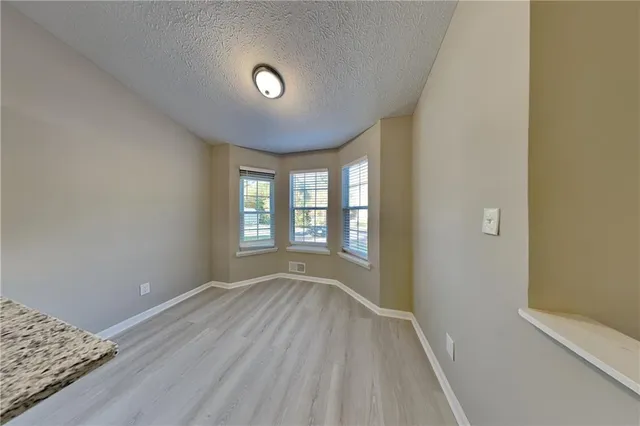 a view of room with window and hardwood floor
