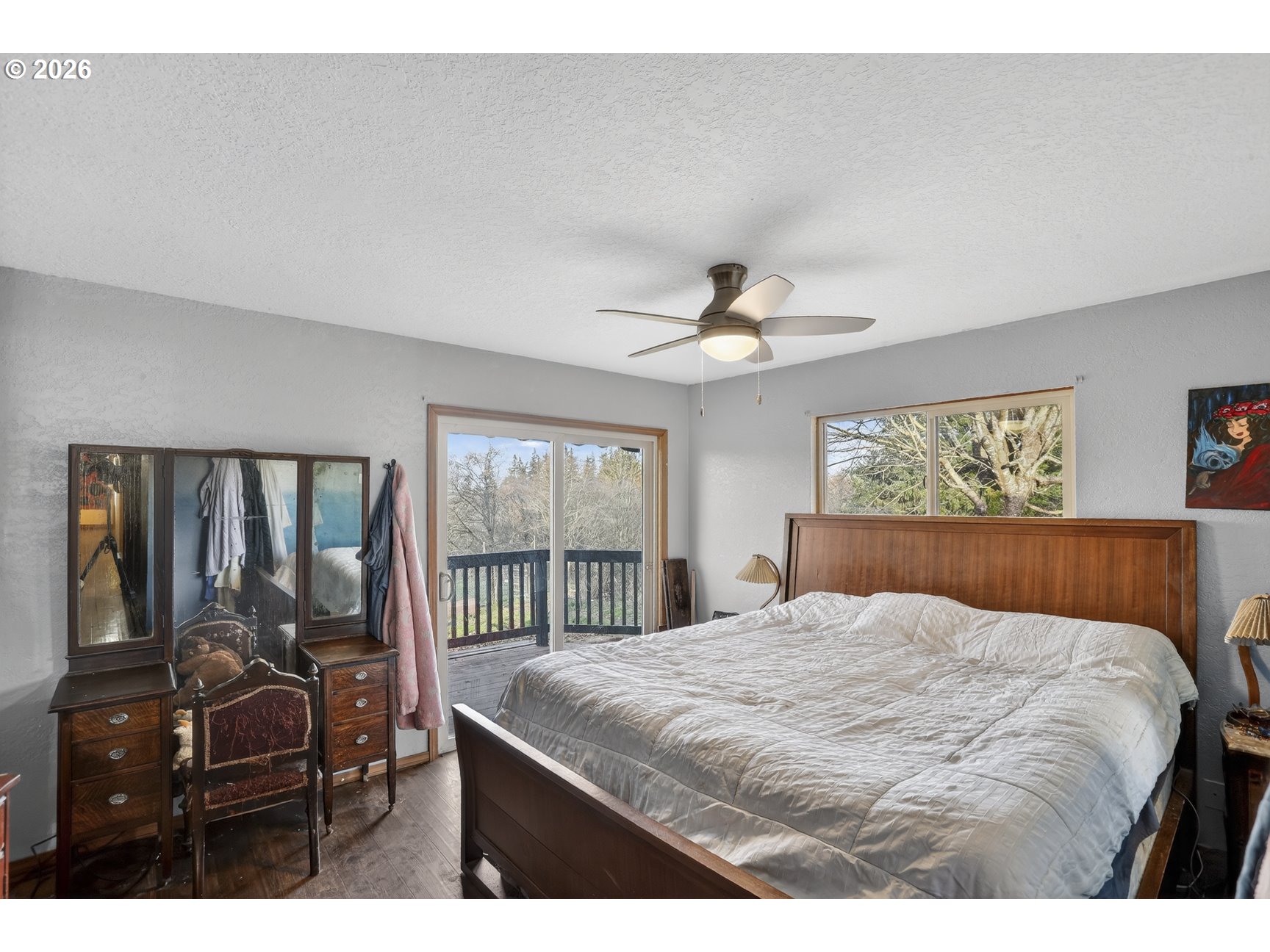 79372 Stewart Creek Road Clatskanie, OR 97016 - Photo 6 of 40 a bedroom with a large bed and a chandelier