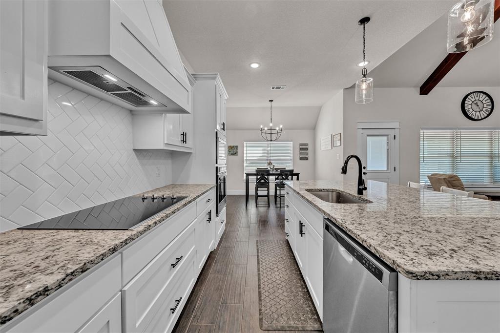3000 Westfork Way Springtown, TX 76082 - Photo 14 of 35 a large kitchen with granite countertop a sink and a stove