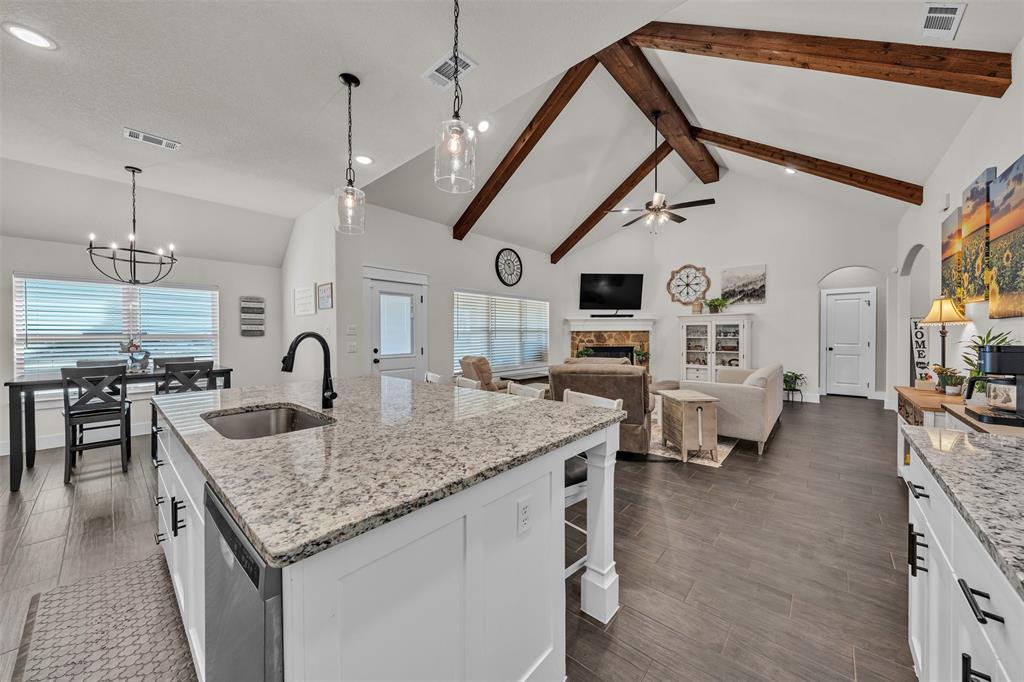 3000 Westfork Way Springtown, TX 76082 - Photo 18 of 35 a kitchen with stainless steel appliances granite countertop a stove and living room view
