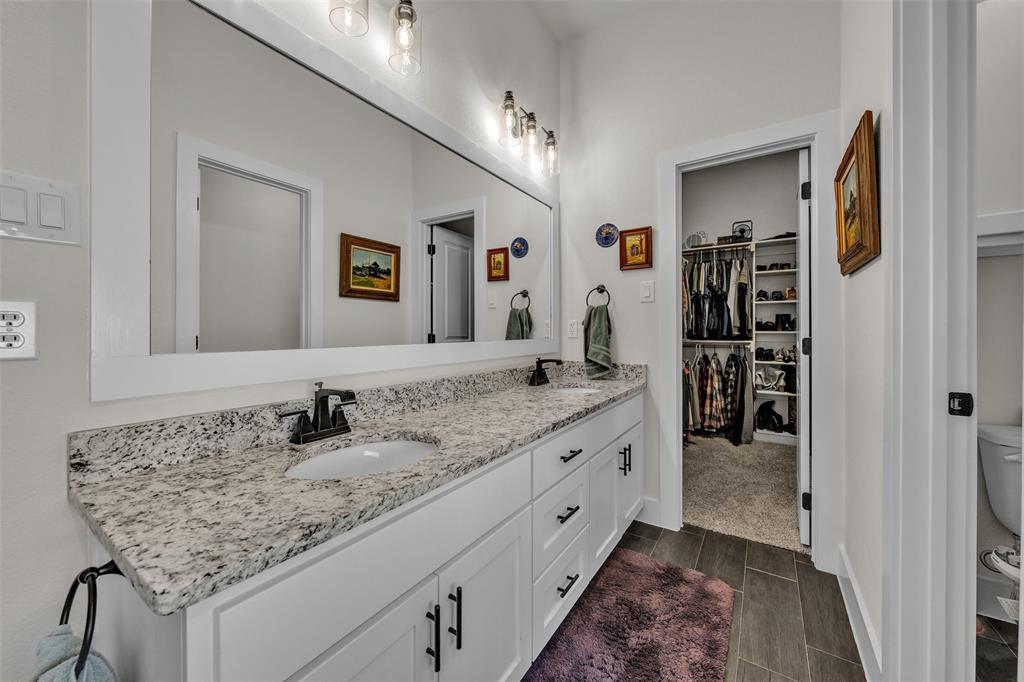 3000 Westfork Way Springtown, TX 76082 - Photo 25 of 35 a bathroom with a granite countertop sink and a mirror