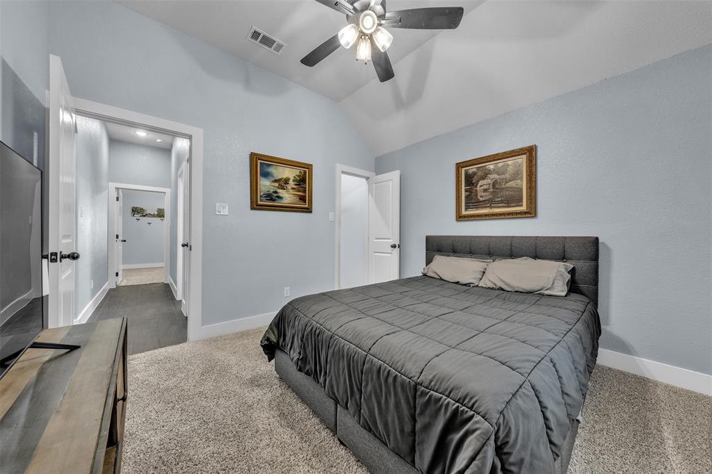 3000 Westfork Way Springtown, TX 76082 - Photo 28 of 35 a bedroom with a large bed and a chandelier
