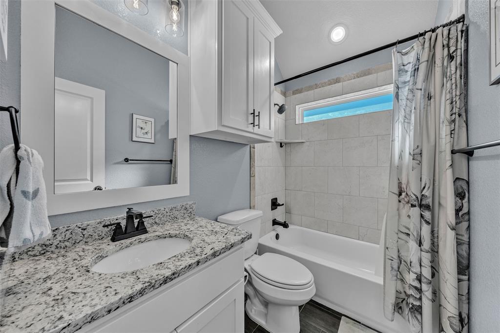 3000 Westfork Way Springtown, TX 76082 - Photo 29 of 35 a bathroom with a granite countertop sink toilet and shower