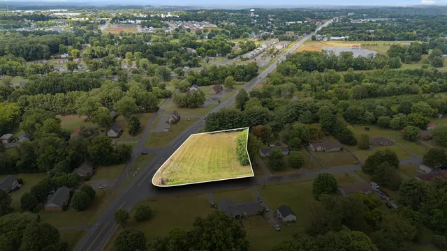 an aerial view of a house with yard