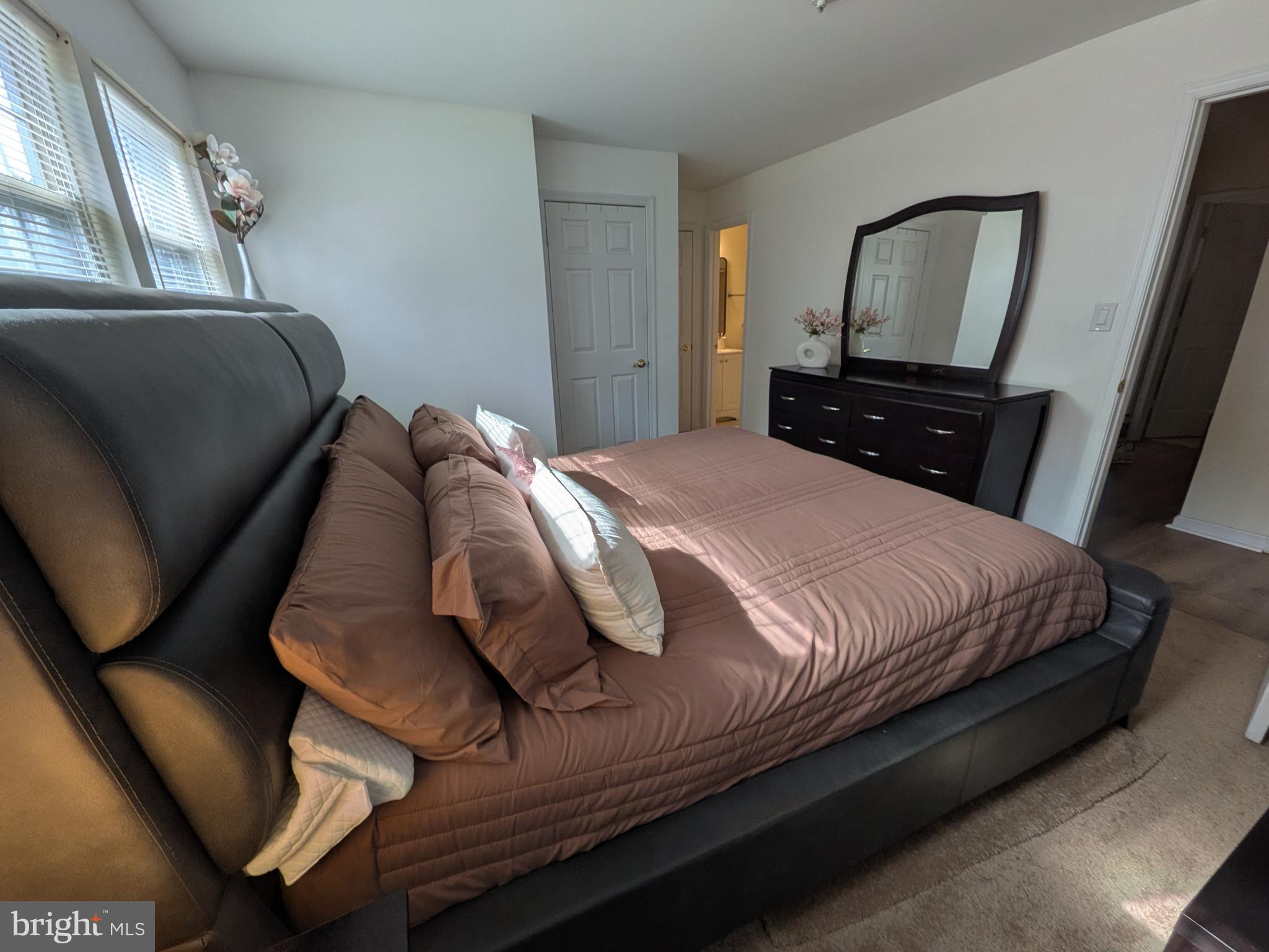 4240 Applegate Lane, Unit 5 Suitland, MD 20746 - Photo 14 of 27 a bedroom with a bed and a mirror