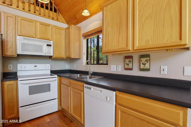 a kitchen with stainless steel appliances granite countertop a sink and a microwave
