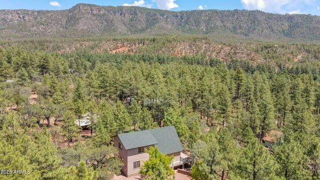an aerial view of a house with yard and outdoor seating
