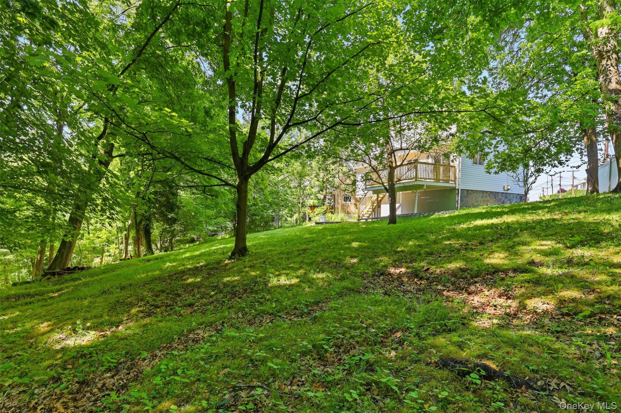 24 Fuller Road Ossining, NY 10562 - Photo 40 of 48 a backyard of a house with lots of green space