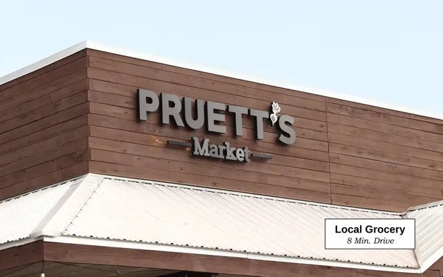 a view of a street with potted plants