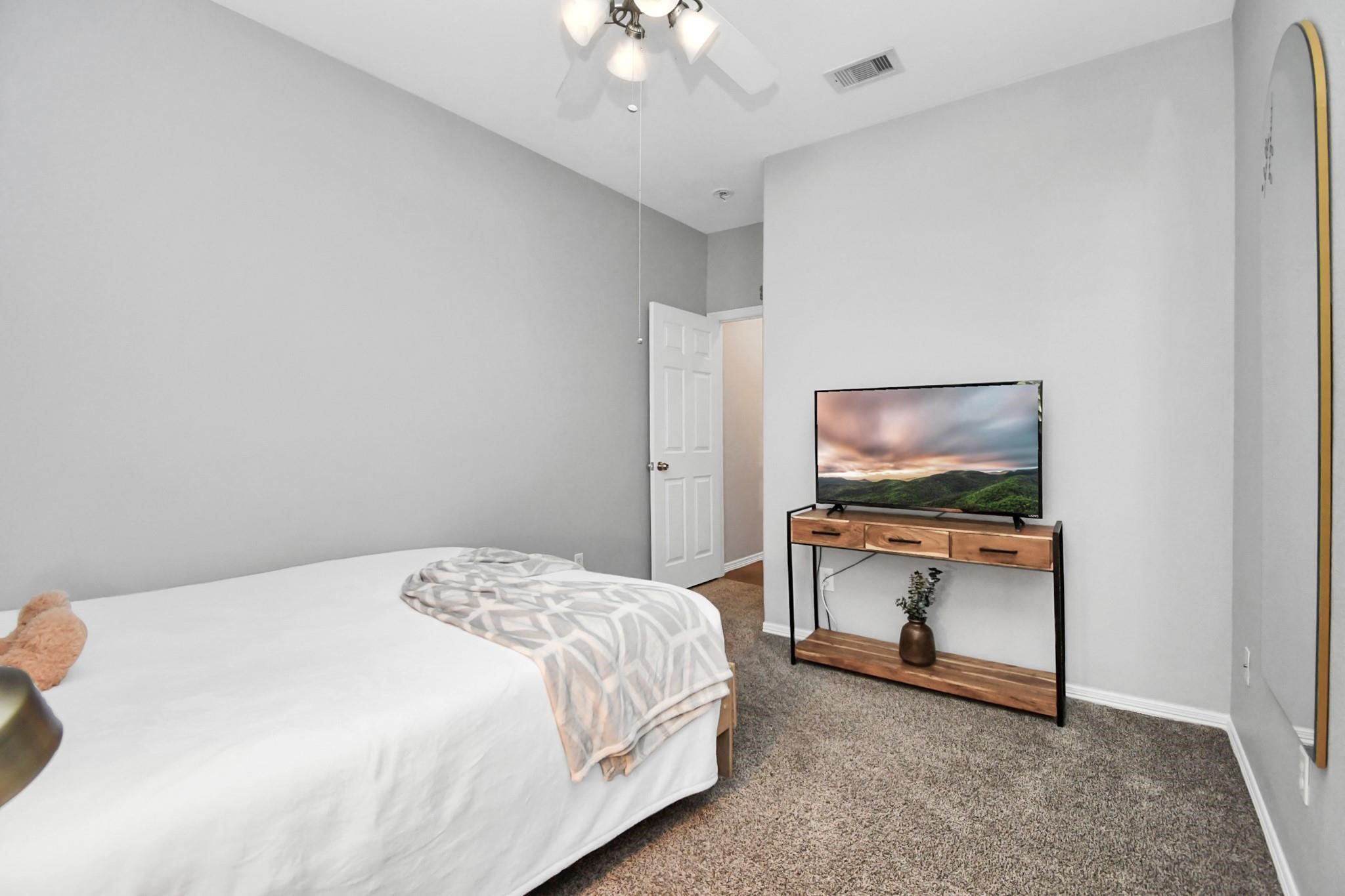 8624 Sunset Loch Drive Spring, TX 77379 - Photo 29 of 44 a bedroom with a bed and flat screen tv