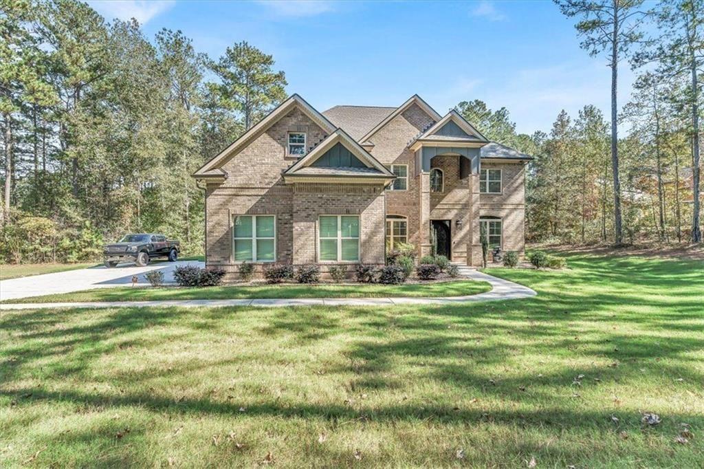 590 Eskew Road McDonough, GA 30252 - Photo 1 of 1 a front view of a house with a garden and porch