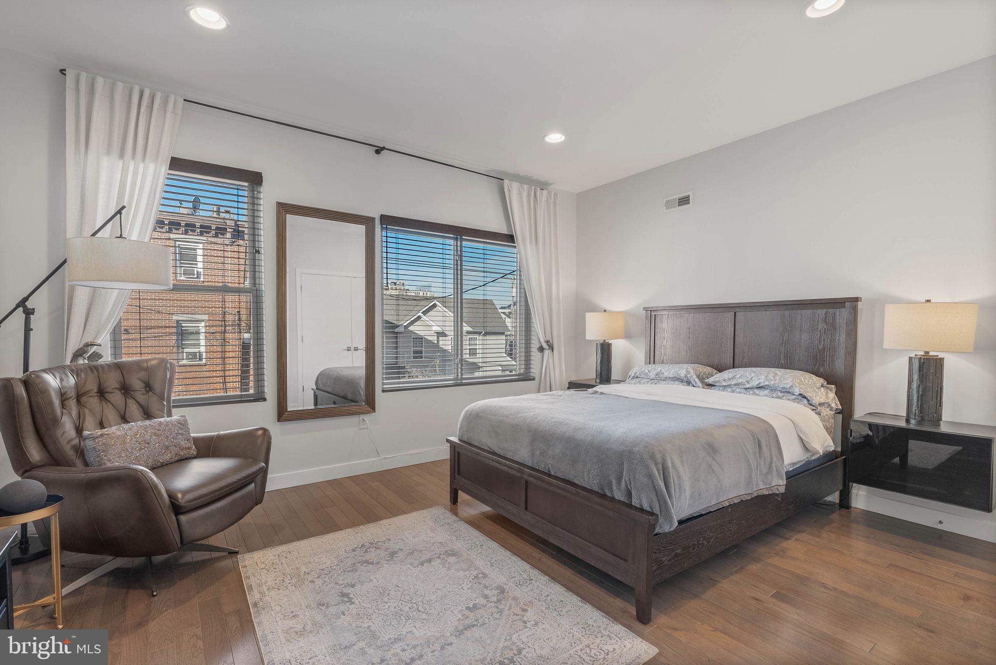 1753 North Marshall Street, Unit B Philadelphia, PA 19122 - Photo 12 of 34 a bedroom with a bed couch and windows