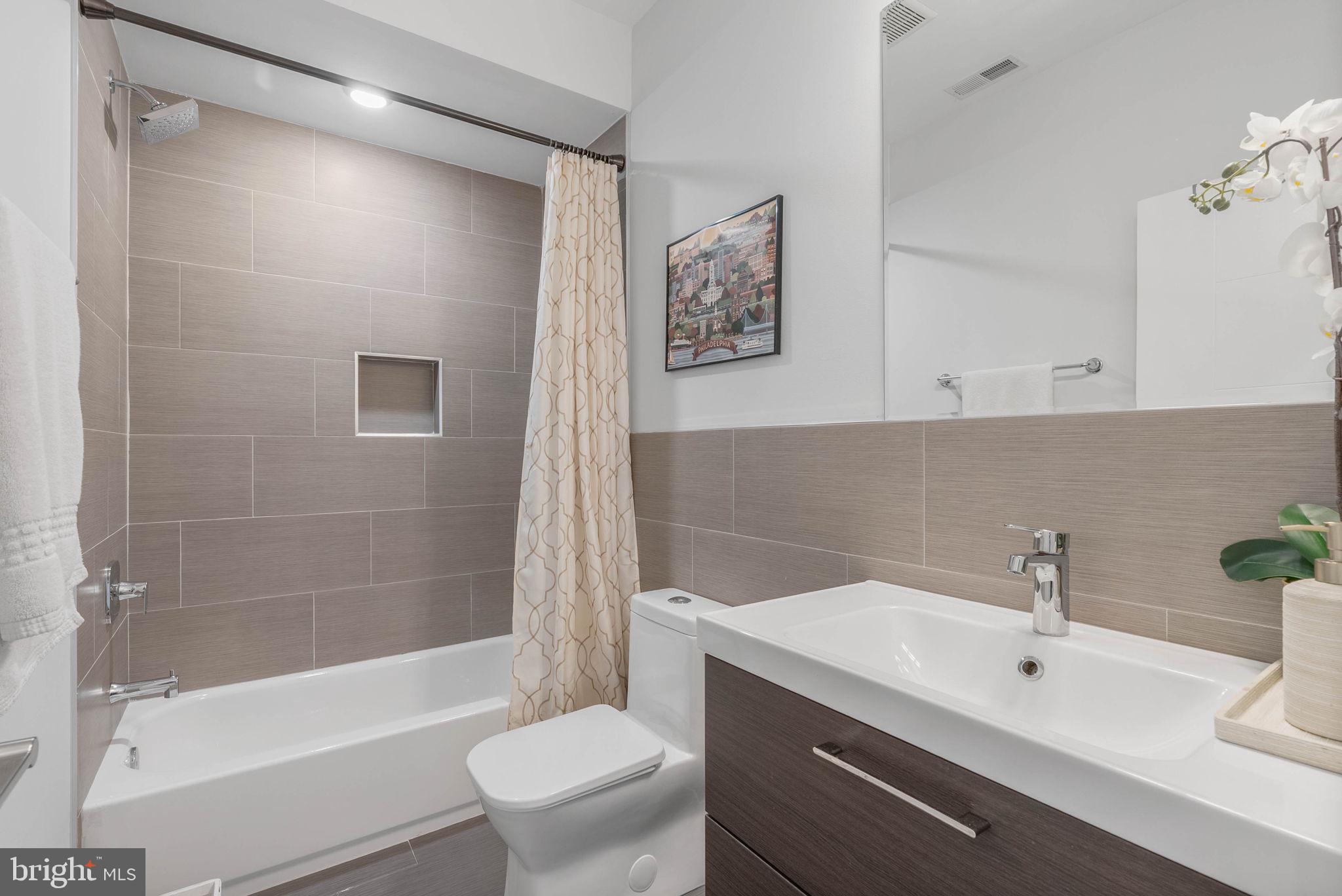 1753 North Marshall Street, Unit B Philadelphia, PA 19122 - Photo 16 of 34 a bathroom with a sink mirror toilet and bathtub
