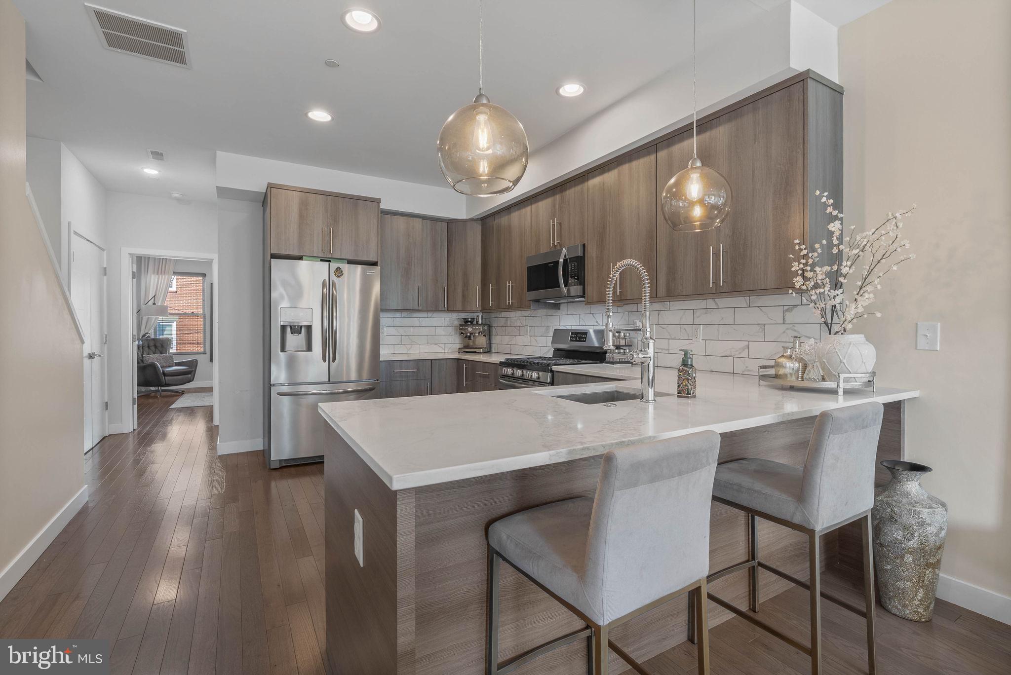 1753 North Marshall Street, Unit B Philadelphia, PA 19122 - Photo 5 of 34 a kitchen with refrigerator and chairs