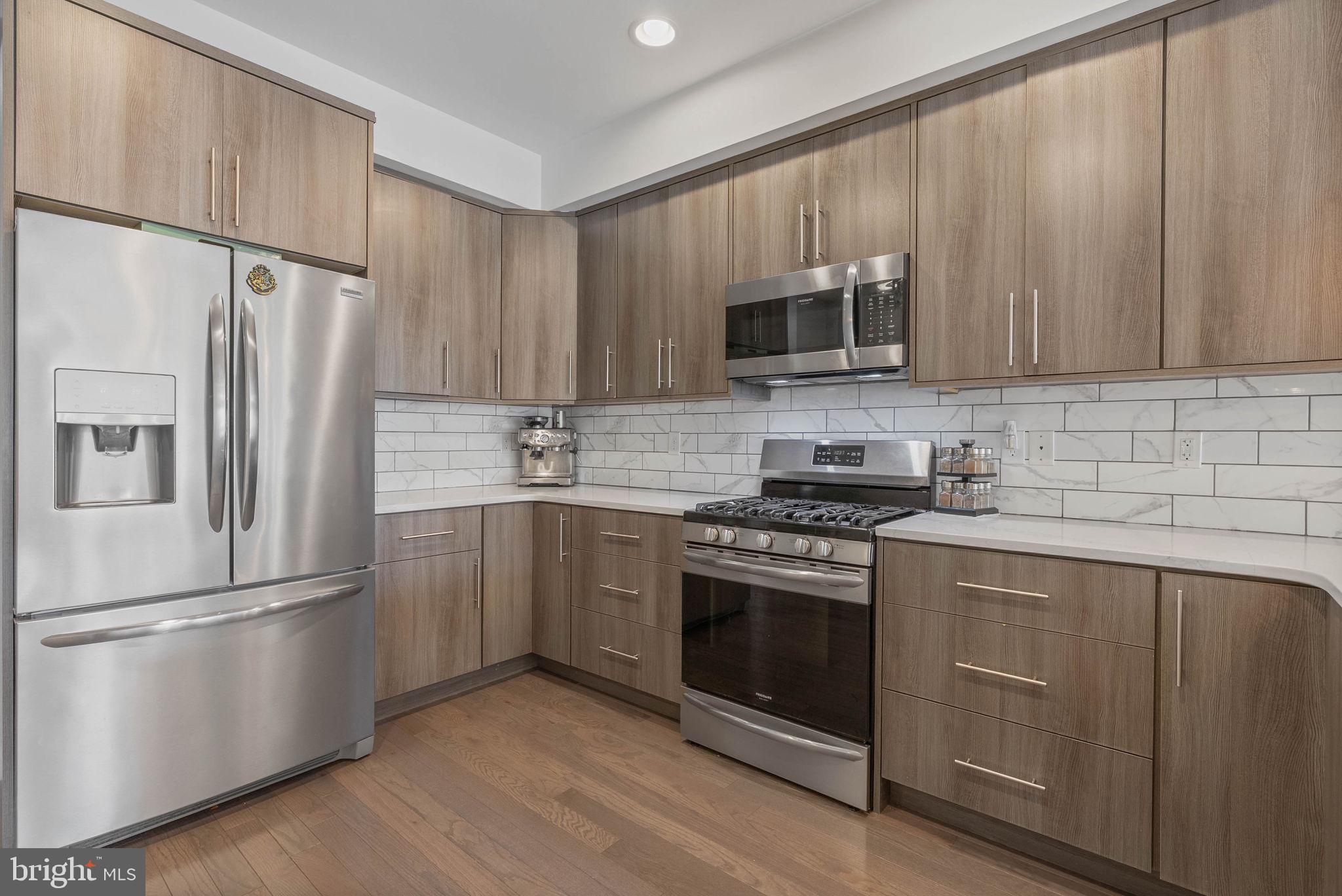 1753 North Marshall Street, Unit B Philadelphia, PA 19122 - Photo 9 of 34 a kitchen with a refrigerator stove and microwave