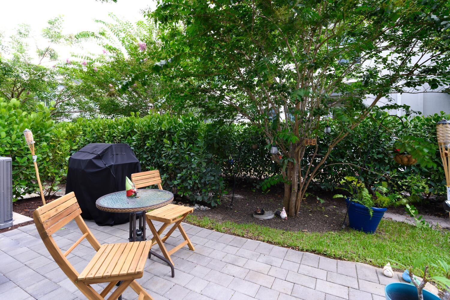 1832 Southeast Roxy Way Stuart, FL 34996 - Photo 13 of 30 a view of a chairs and table in backyard of the house