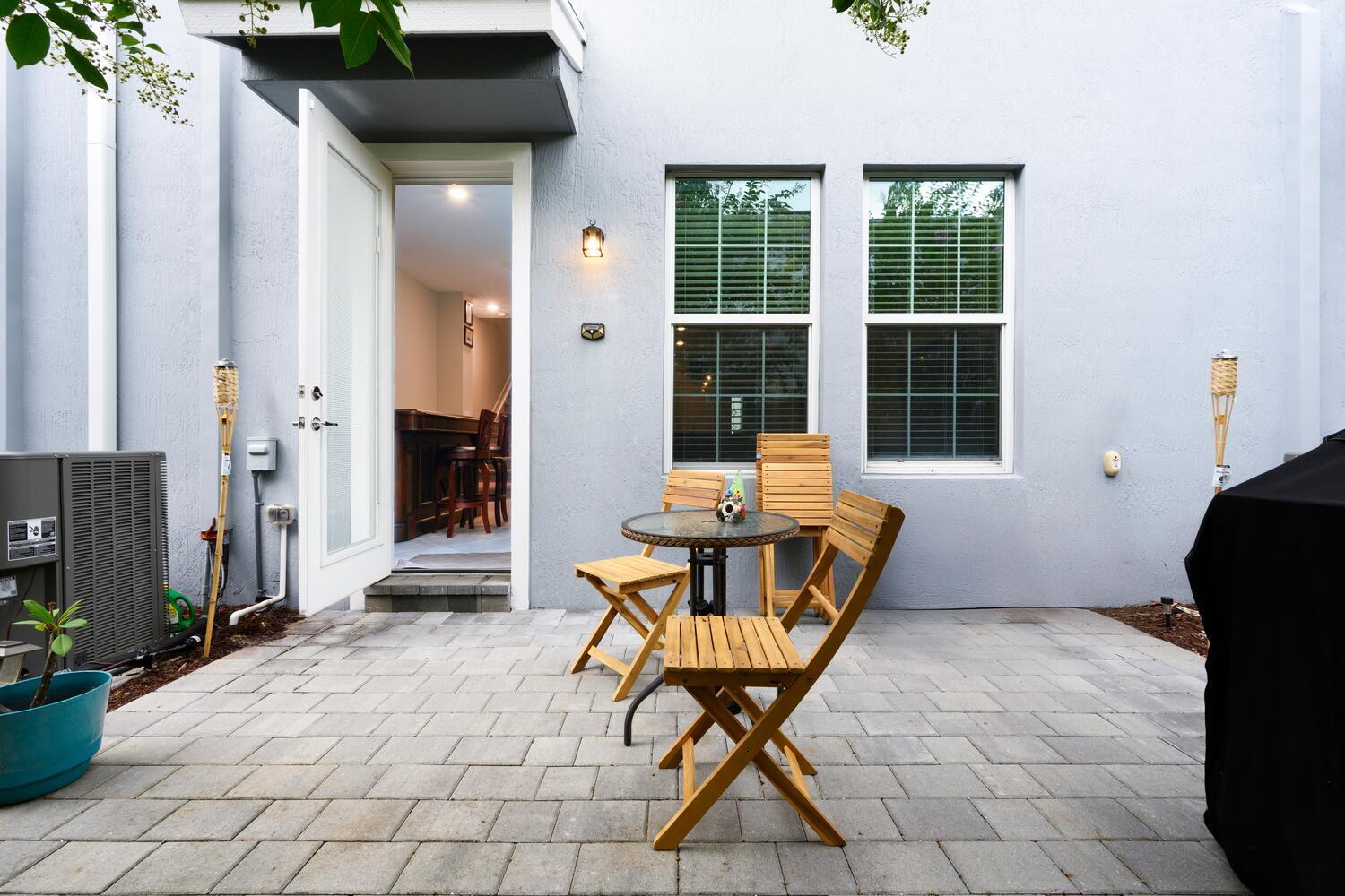 1832 Southeast Roxy Way Stuart, FL 34996 - Photo 15 of 30 a building outdoor space with patio furniture and potted plants