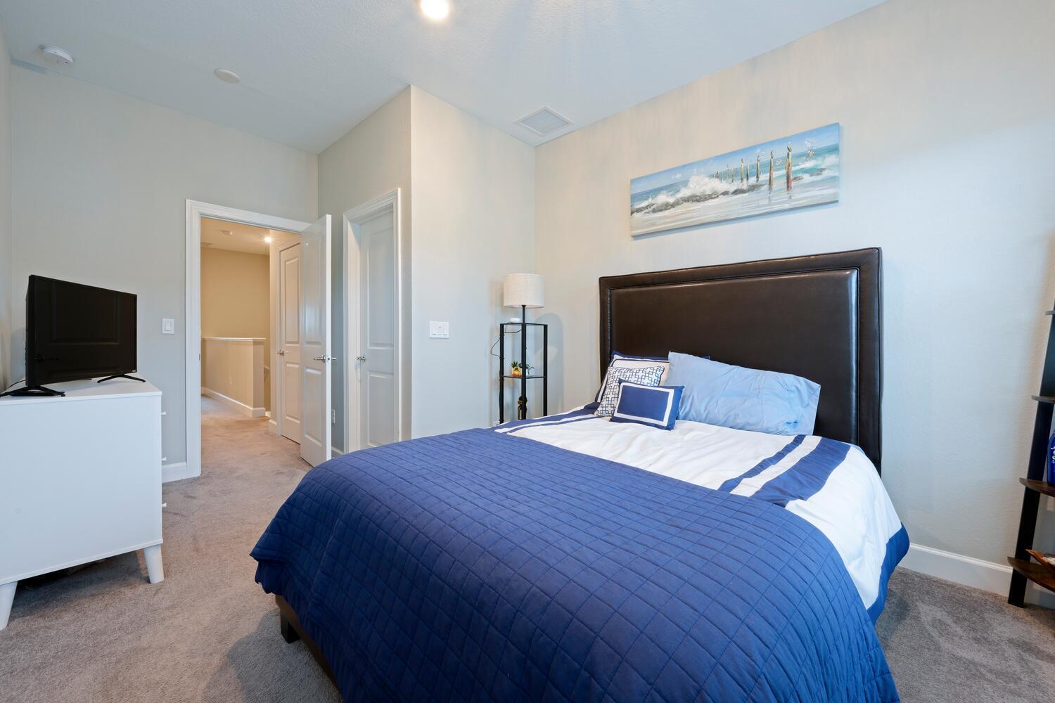 1832 Southeast Roxy Way Stuart, FL 34996 - Photo 23 of 30 a bedroom with a bed and a flat screen tv