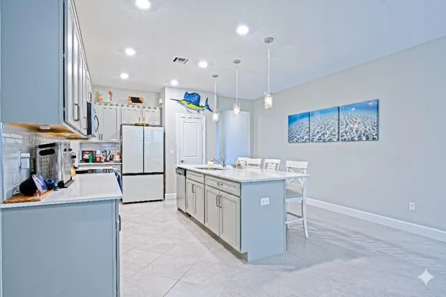 a kitchen with a sink appliances and cabinets