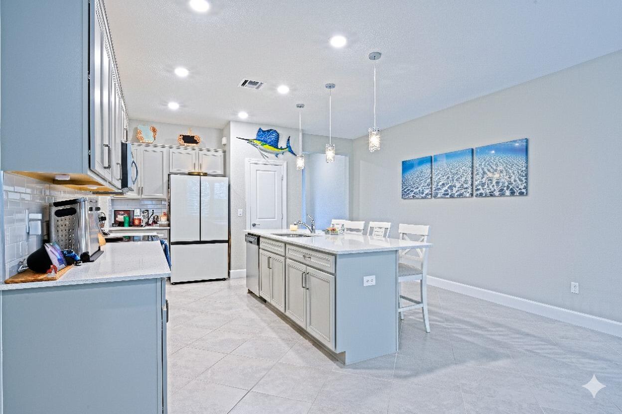 1832 Southeast Roxy Way Stuart, FL 34996 - Photo 6 of 30 a kitchen with a sink appliances and cabinets