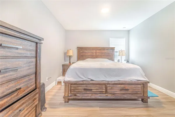 a bed sitting in a bedroom next to a window