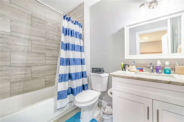 a bathroom with a toilet and a shower curtain