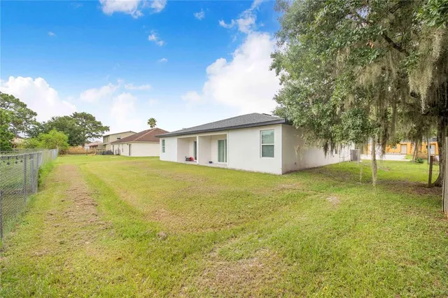 a view of a house with a yard and sitting area